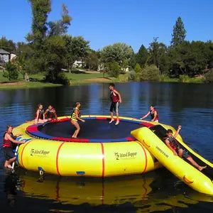 Island Hopper Water Trampoline on a lake with several kids playing on it.