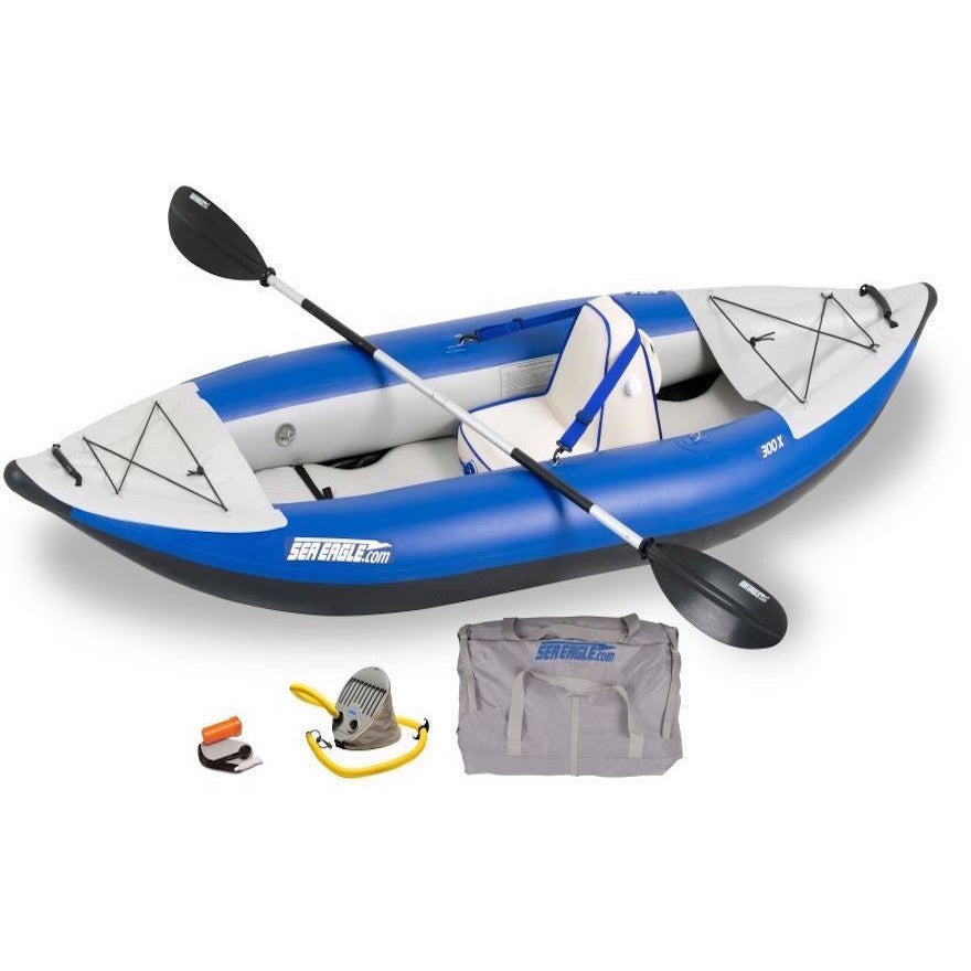 Blue and Grey Sea Eagle Explorer 300X Solo Inflatable Kayak top and side display view with the bag and pump sitting next to the Sea Eagle inflatable kayak. 