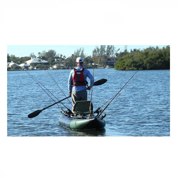 Sea Eagle 350fx Inflatable Fishing Kayak out on the water with several fishing poles set up and a paddler standing up.