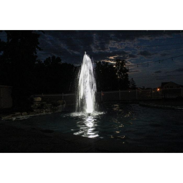 Bearon Aquatics .33 Hp Fixed Base Olympus Pond Fountain spraying water up in the air with a light on it.