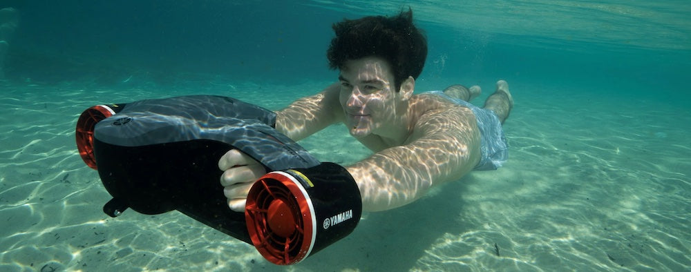 Image for our blog: Sea Scooters for Sale, Why are they, and Why do I need one. A young man is under water with a sea scooter for sale and enjoying a snorkeling adventure with a Yamaha Seawing 2 Sea Scooter for Sale.