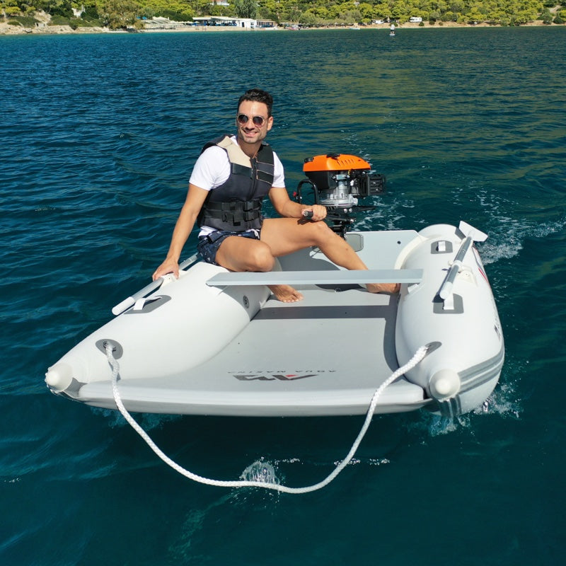 Man on a small inflatable boat with a motor in the water
