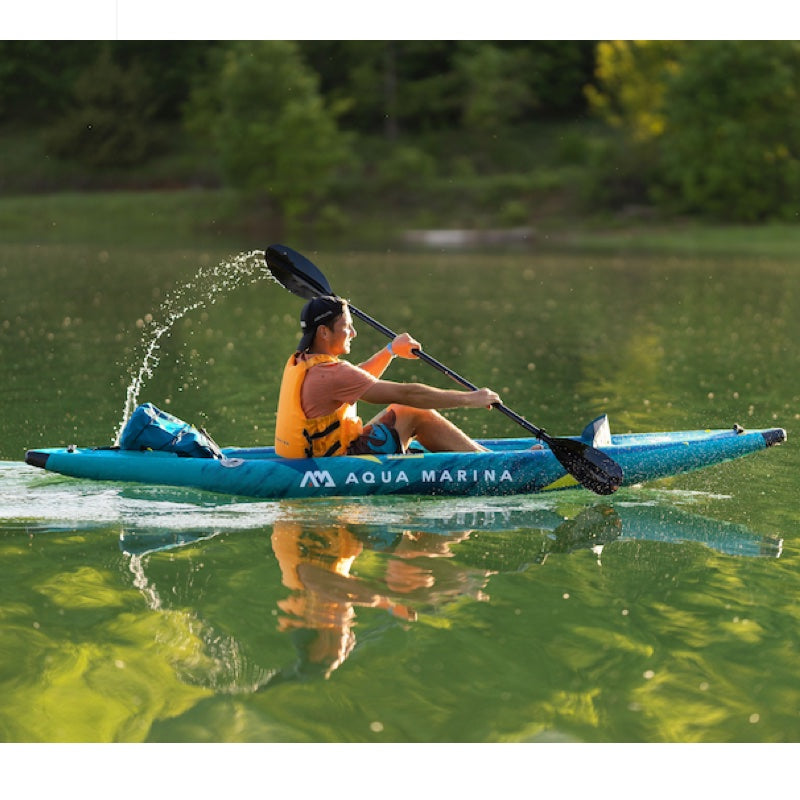 Person kayaking on a lake with Aqua Marina kayak
