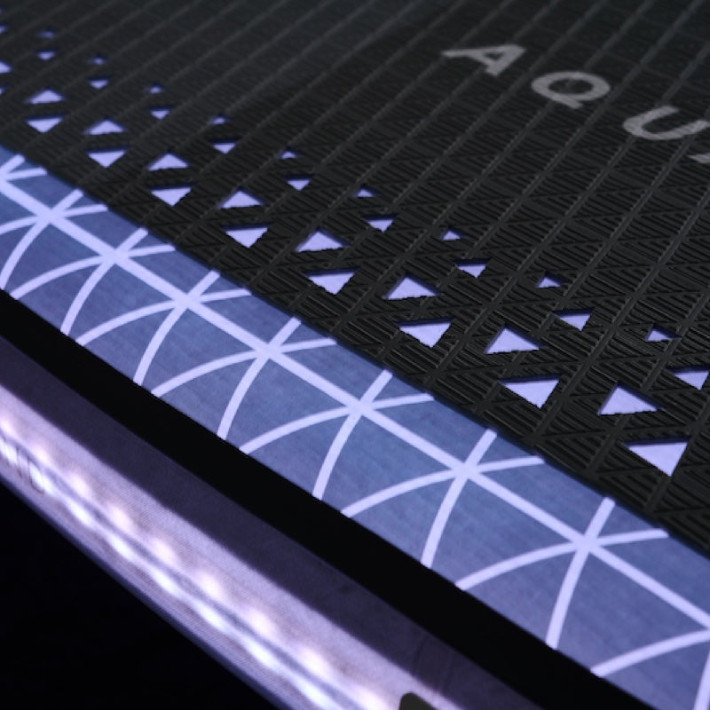 Close-up of a textured surface with geometric patterns illuminated
