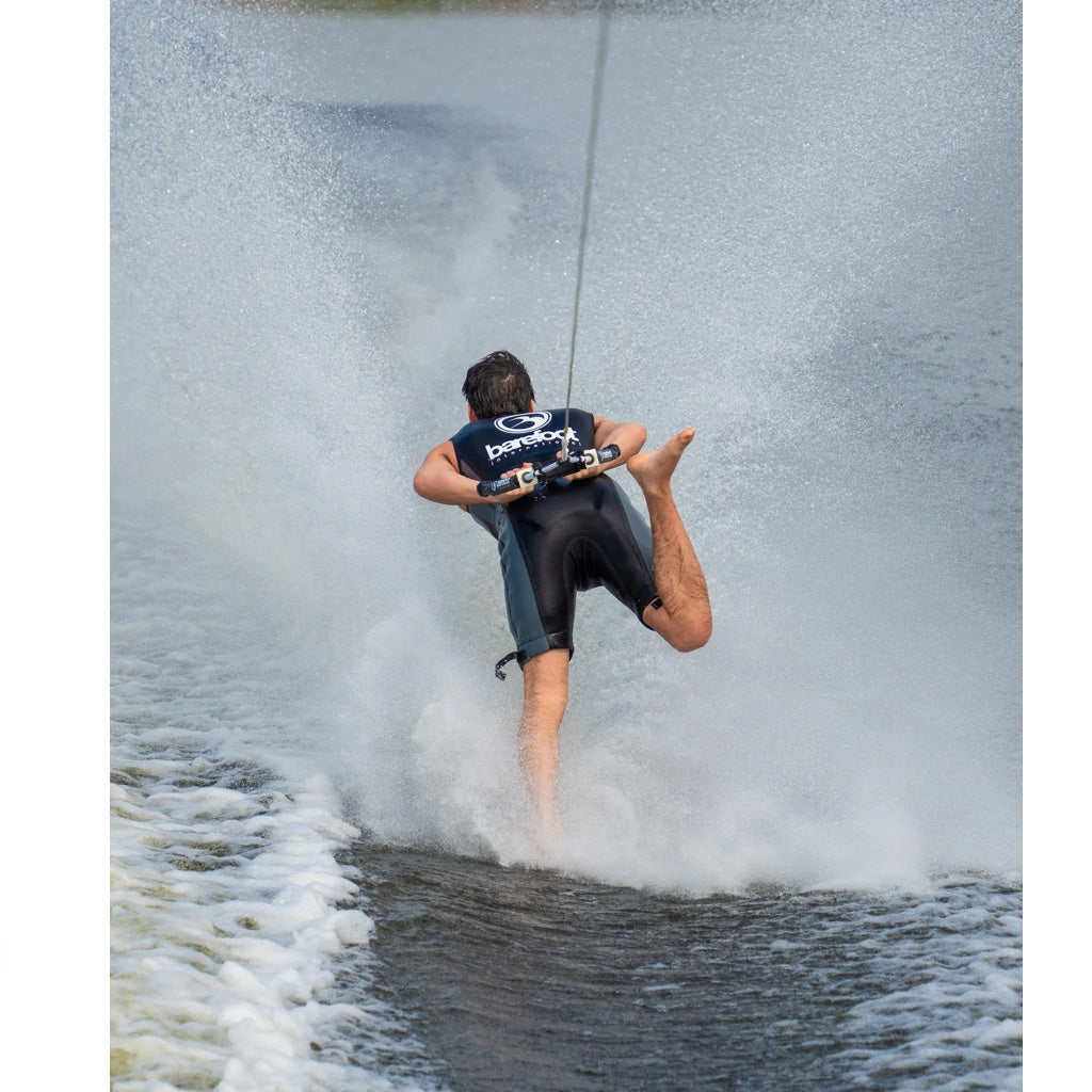 A man barefoot skies backwards in his new iron sleeveless wetsuit.