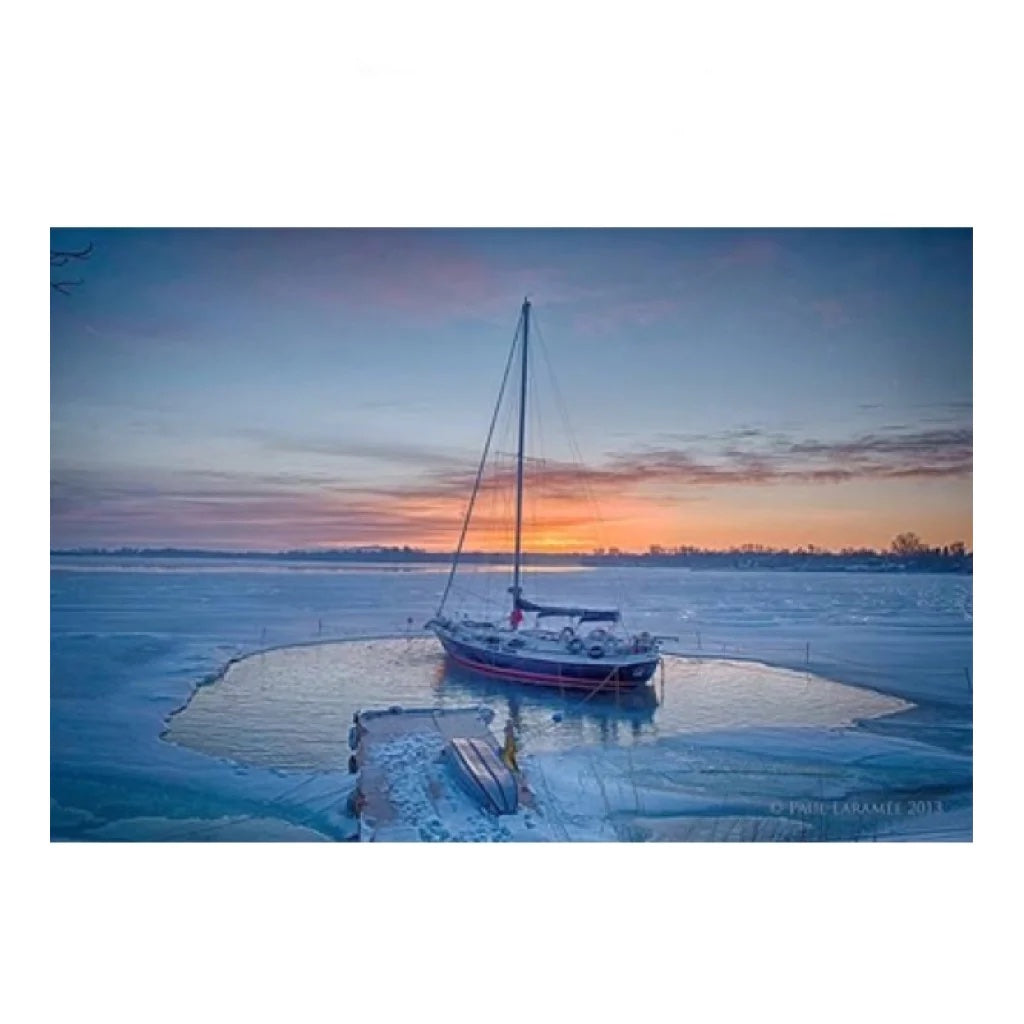 Bearon Aquatics P1000 Ice Eater - 1 Hp attached to a small sailboat in the middle of a frozen lake.