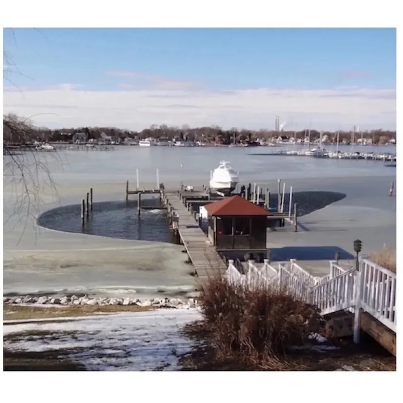 Power House Ice Eater at work from a distance that carved out parts of the frozen water around the port.