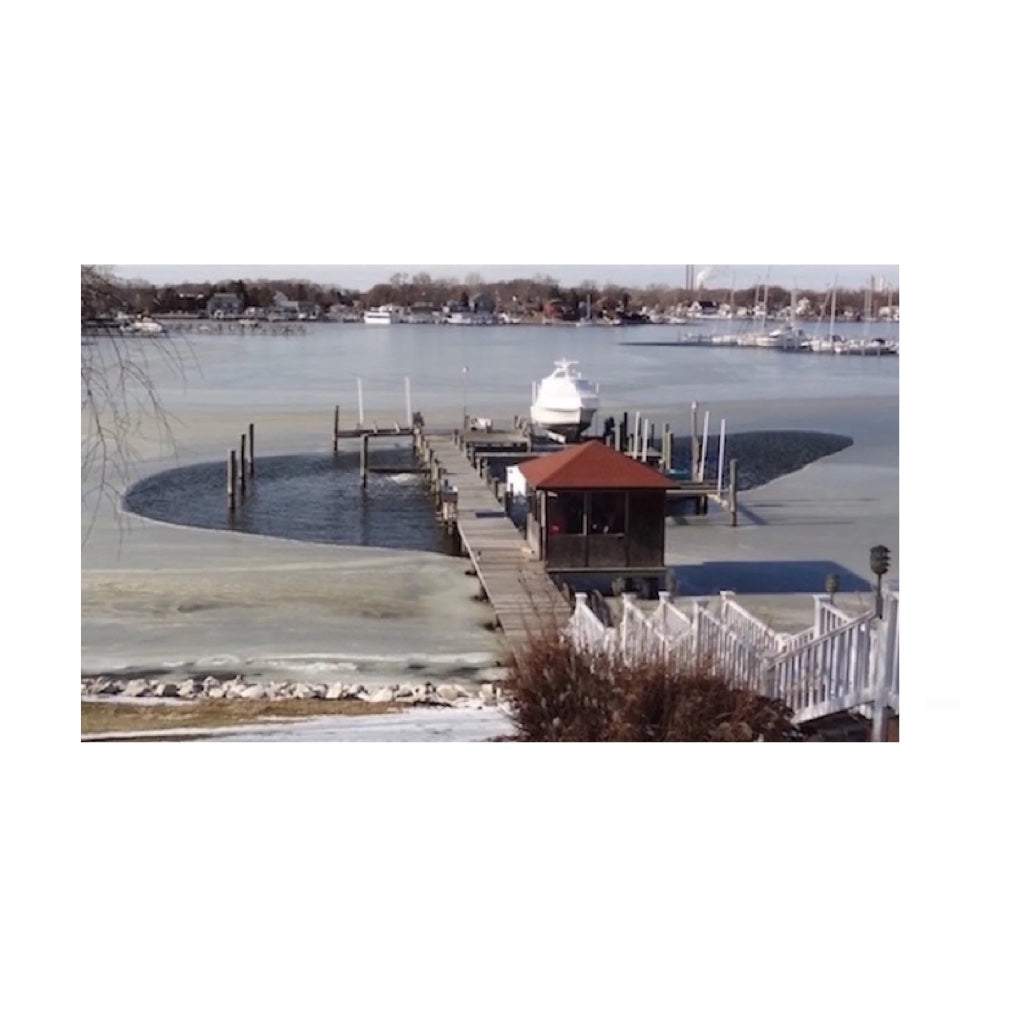 Bearon Aquatics P250 Ice Eater - 1/4 Hp at work from a distance that carved out parts of the frozen water around the port.