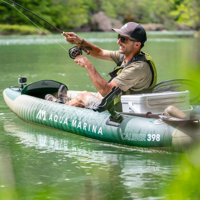 Man fishing from an Aqua Marina inflatable angler kayak on a calm lake
