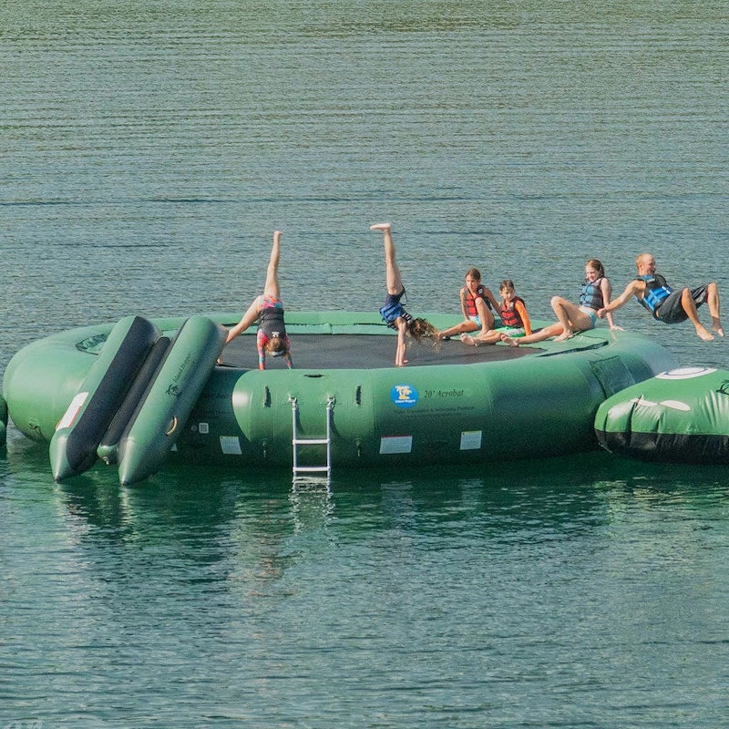 Inflatable water trampoline park with a slide on a lake with children playing