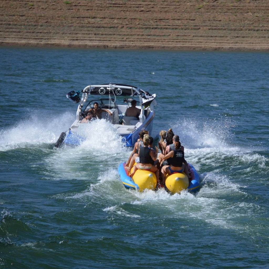Island Hopper 10-Person Banana Boat Tube pulled behind a wake boat.