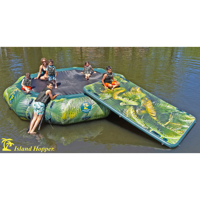 This is the Island Hopper 15ft Lakeside Series Water Bouncer with 1 slide attached in action on the lake and an adult female sitting on it along with 5 children of various ages playing.