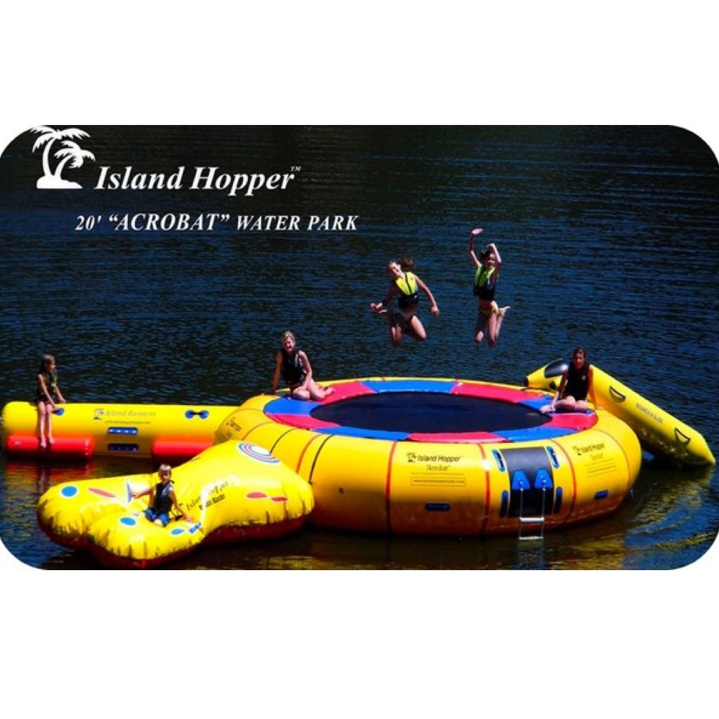 Island Hopper Acrobat Water Trampoline Park. 2 Teenage girls jump on thw water trampline while other friends and parents relax on the edge and play on the attachments.