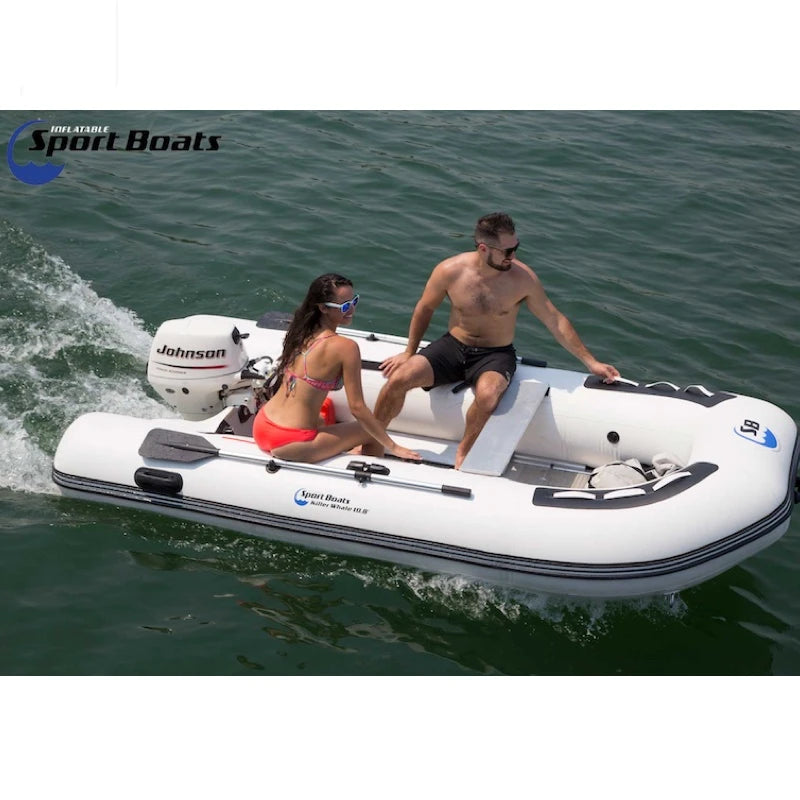 Two people on an inflatable boat with a Johnson outboard motor, branded 'Island Hopper X Inflatable Sport Boats'.