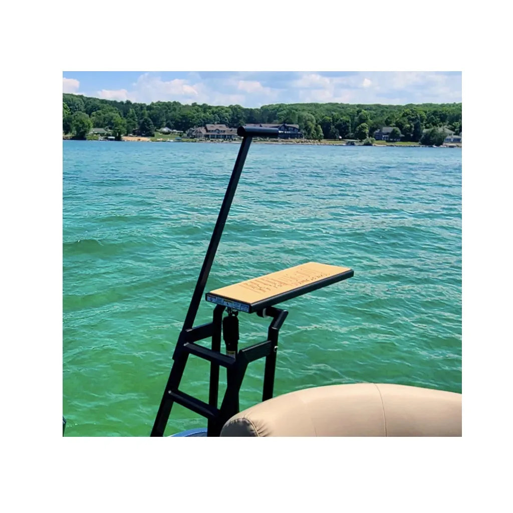 This is the Lillipad Diving Board with the black powder-coated finish of the Mocha/Black variation rested on the edge of the boat in the middle of the sea.
