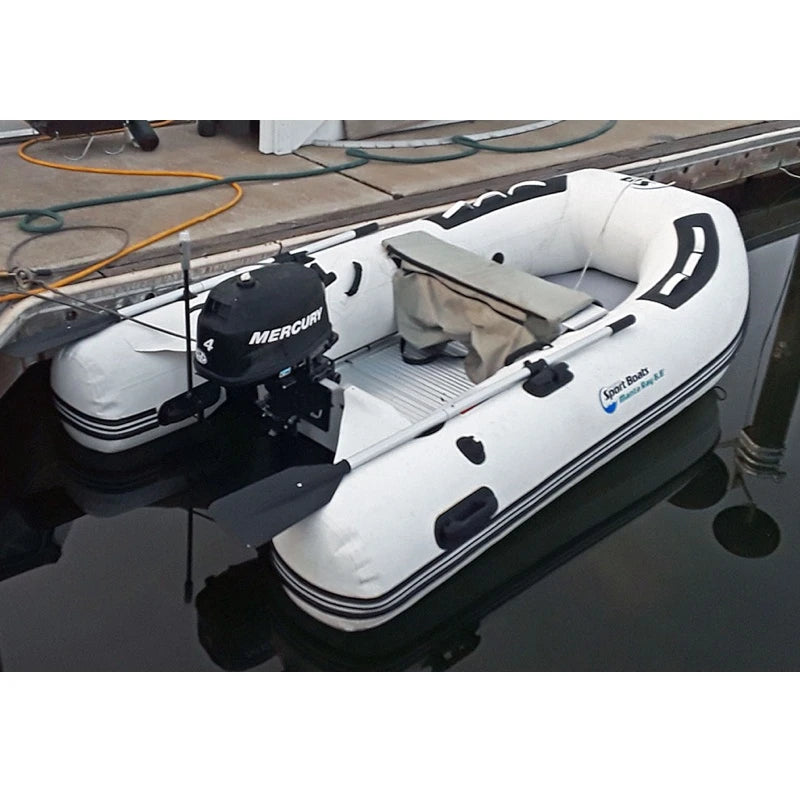 White inflatable boat with Mercury outboard motor on a dock