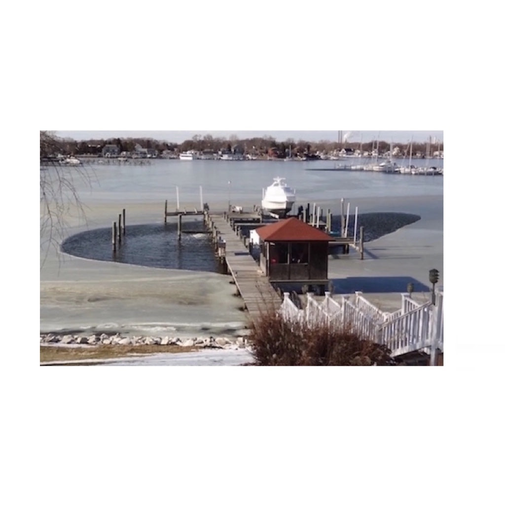Bearon Aquatics P750 Ice Eater - 3/4 Hp at work from a distance that carved out parts of the frozen water around the port.
