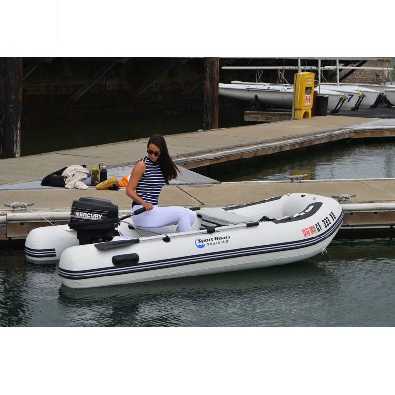 Woman preparing an inflatable boat with a motor on a dock