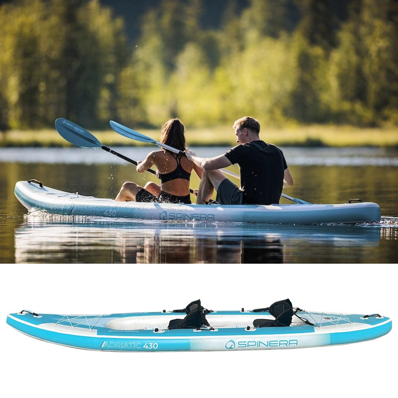 Two people paddling a Spinera Adriatic kayak on a lake with trees in the background.