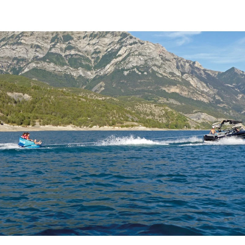 Two boats on a lake with mountains in the background