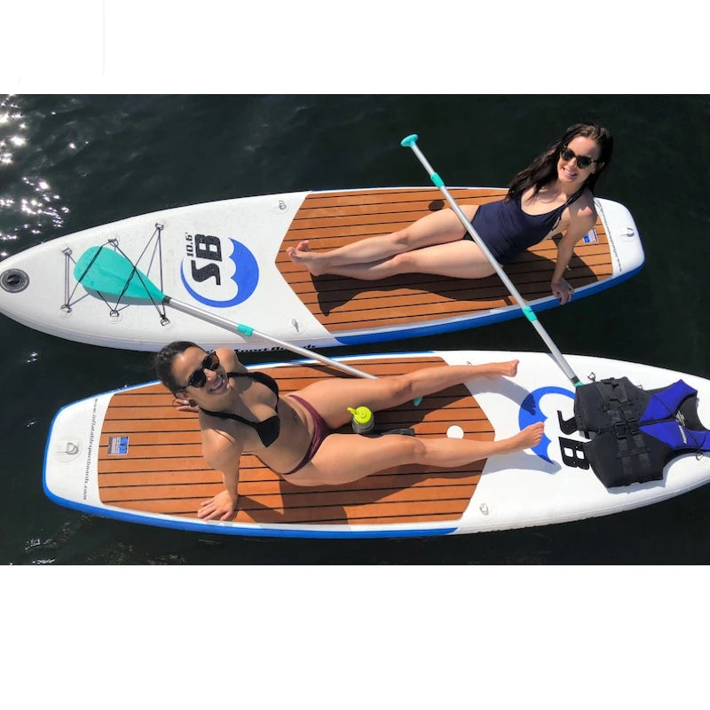 Two women on stand-up paddleboards with a visible brand logo.