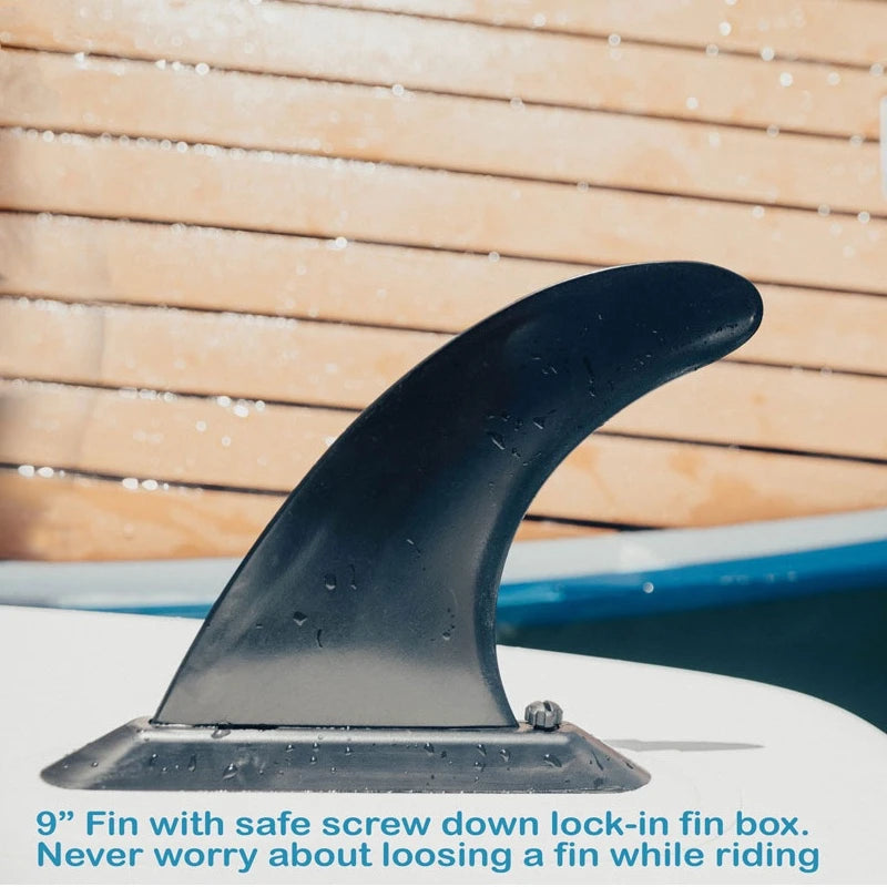 Black surfboard fin with text on a wooden surface