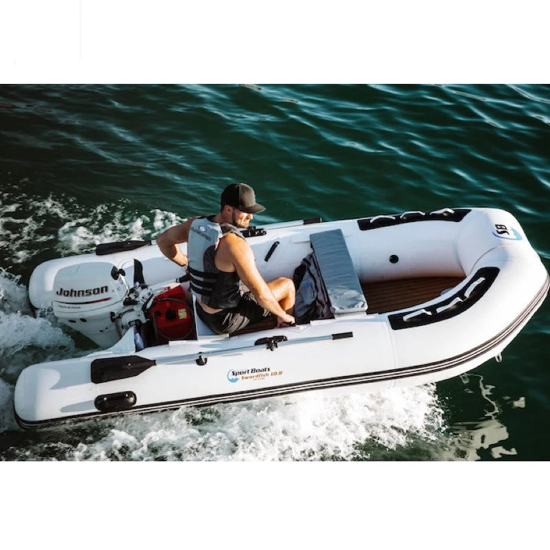 Person on a white inflatable boat with a Johnson outboard motor on a body of water.