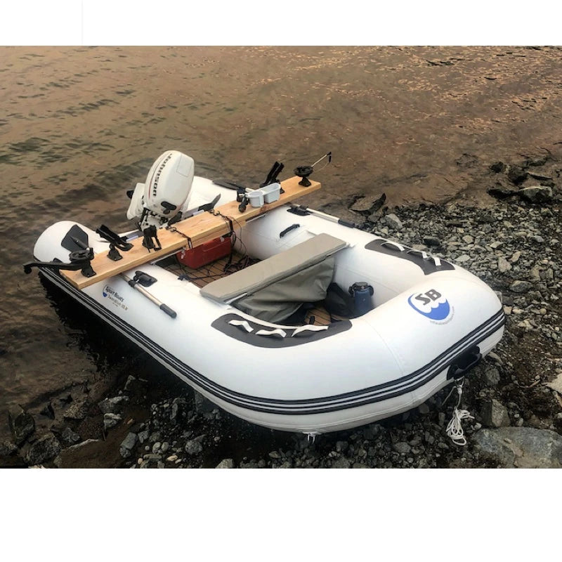 Inflatable boat with fishing gear on a rocky shore