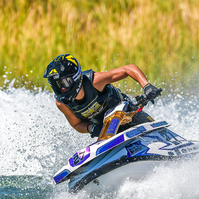 This is the Gray Camo Jetpilot F-86 Sabre John Wetsuit worn by a person while driving a jetski.