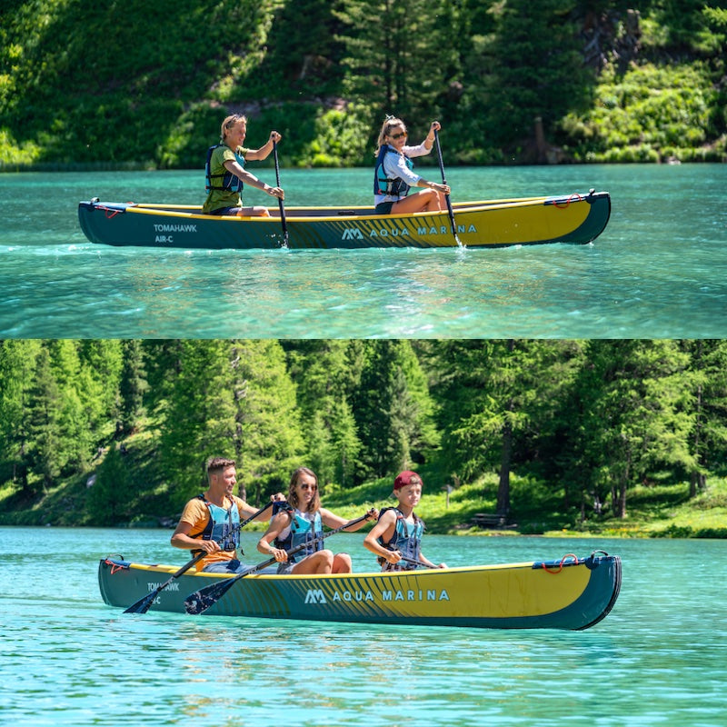Two people paddling a yellow and green inflatable canoe on a lake with trees in the background.