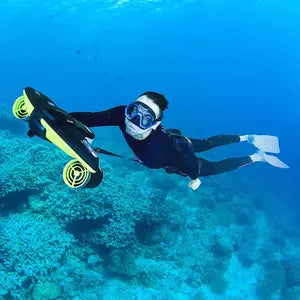 An underwater scooter is used by a scuba diver.