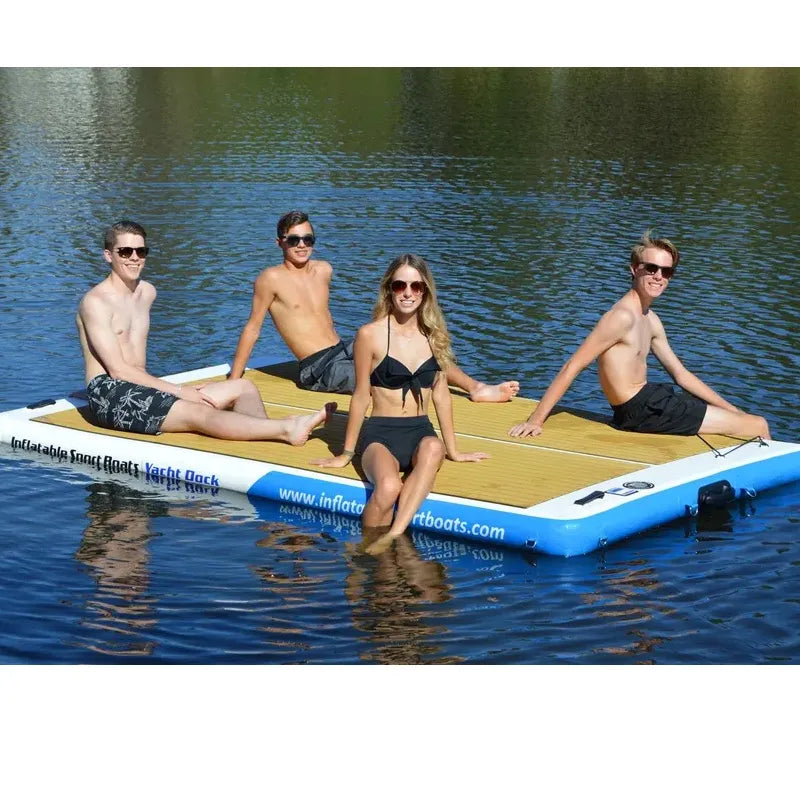 Four people on an inflatable platform in a body of water