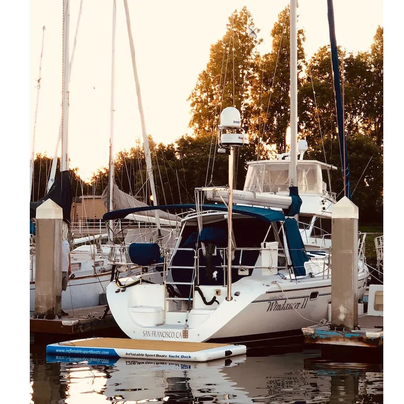 Yacht dock behind a white sailboat in a marina.