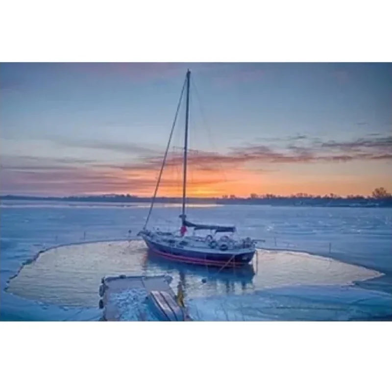 Airmax Ice Eater protecting a small sailboat in the middle of a frozen lake.