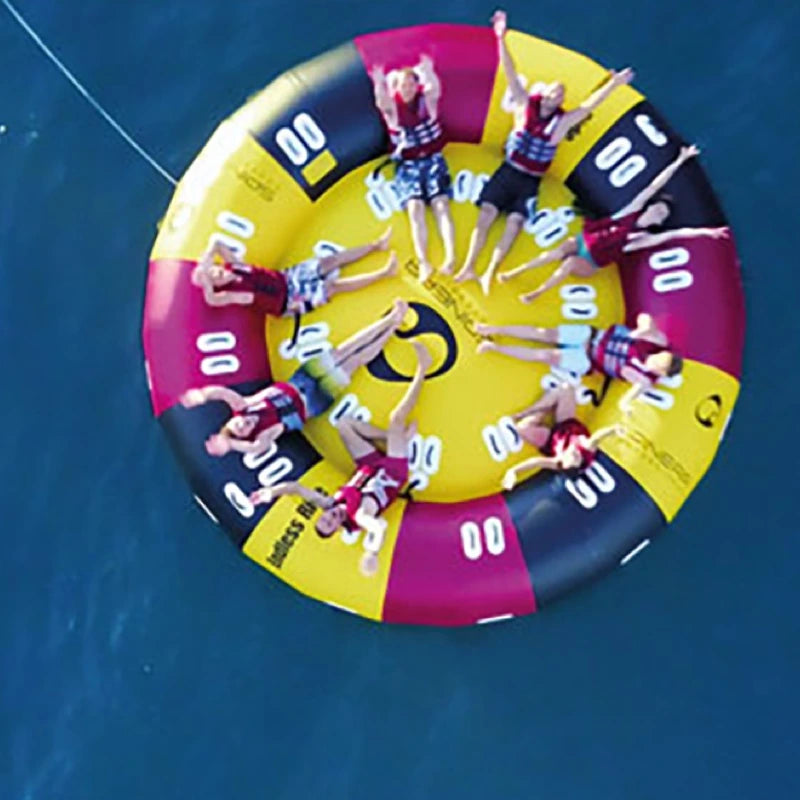 Large inflatable boat tube with people aboard on a blue water background