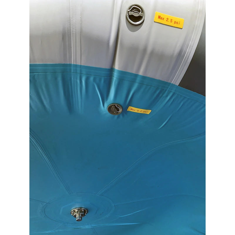 Close-up of an aqua and gray cylindrical container with metal clasps and yellow labels.