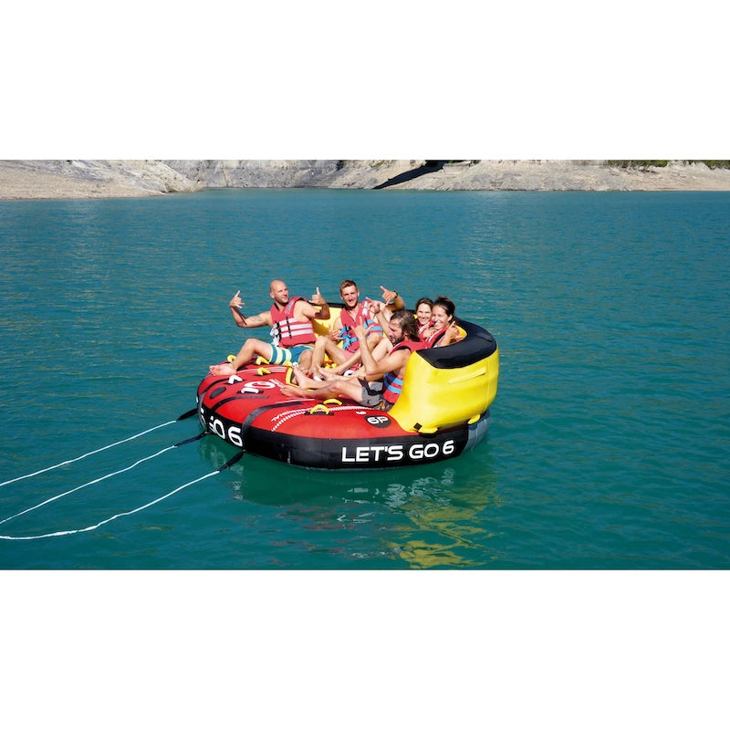 Group of people on an inflatable tube in a lake with 'Let's Go 6' text.