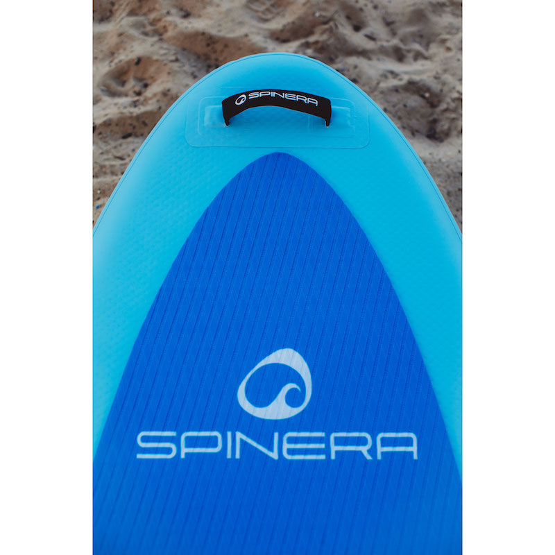 Blue and turquoise Spinera paddlefboard on a sandy background