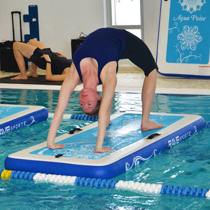 This is an image of a woman doing a yoga position on the Rave Aqua Poise Fitness Mat in the pool. The woman is bending her body backwards on the mat.