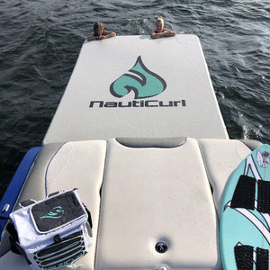 NautiPad Inflatable Swim Mat attached to the boat.