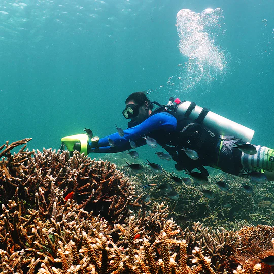 HyperGoGo Manta Sea Scooter in action underwater by a coral garden.