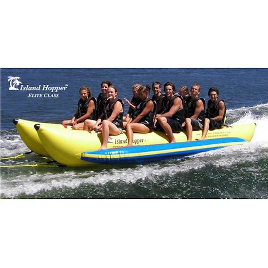 Side view of the yellow Island Hopper 10 Person Banana Boat Tube ridden by 10 adult men, splashing across the lake.