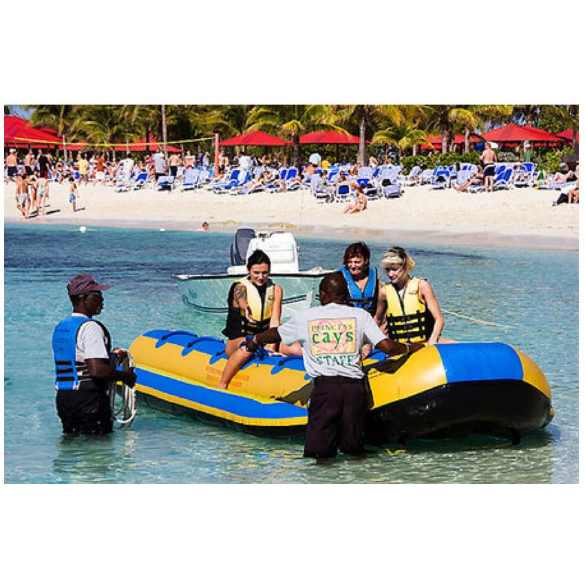 Passengers being assisted boarding the Island Hopper 12 Person Towable Banana Boat Taxi in the ocean.