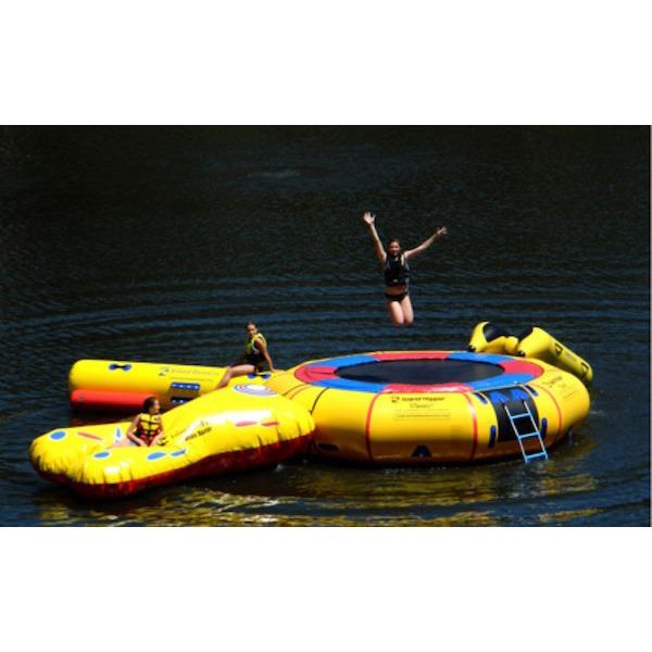 View of the Island Hopper 15' Classic Water Trampoline with several water park attachments.