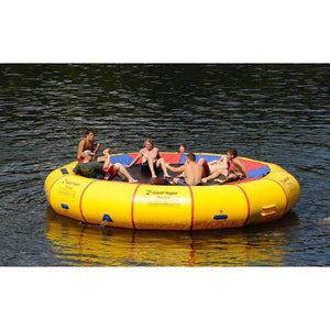 Several young boys sitting on the yellow Island Hopper 20' Acrobat Water Trampoline