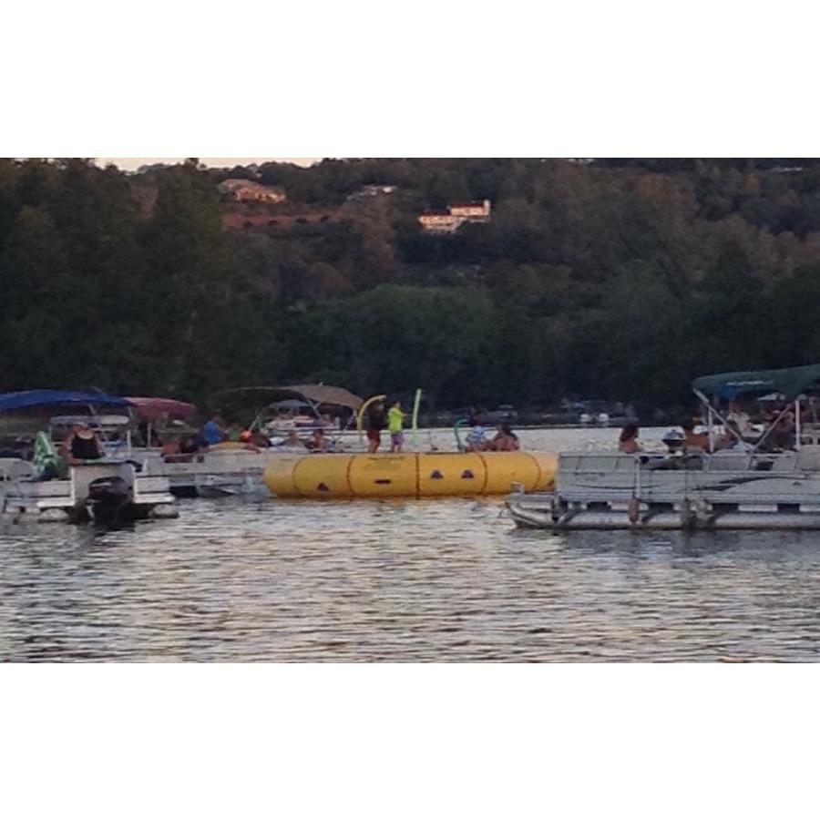 Island Hopper 20 Acrobat Water Trampoline surrounded by pontoon boats on the lake. 