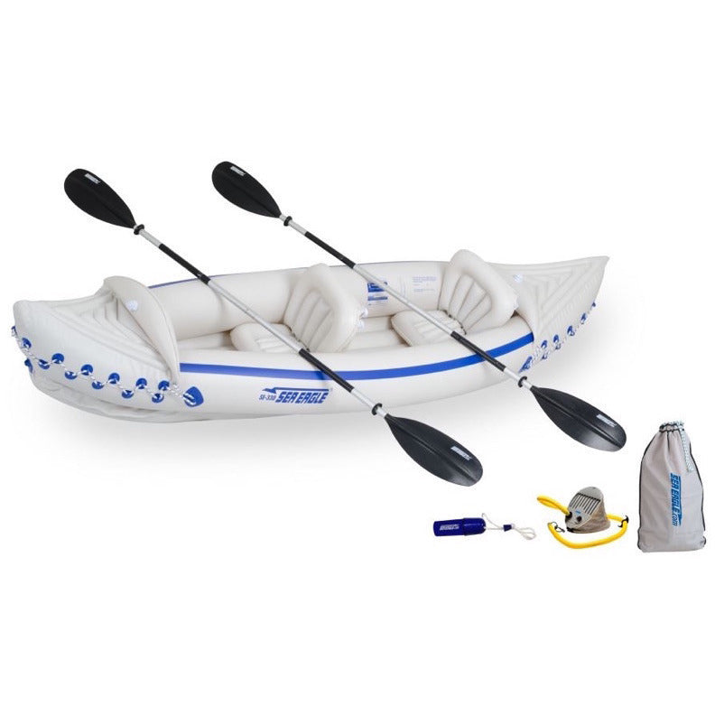 White and blue Sea Eagle 330 Sport Inflatable Kayak top view with the bag and pump sitting next to the Sea Eagle inflatable boat.