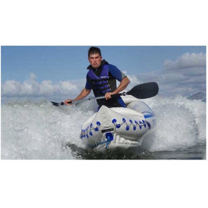 Sea Eagle 330 Sport Inflatable Kayak splashing through the water with a man paddling.