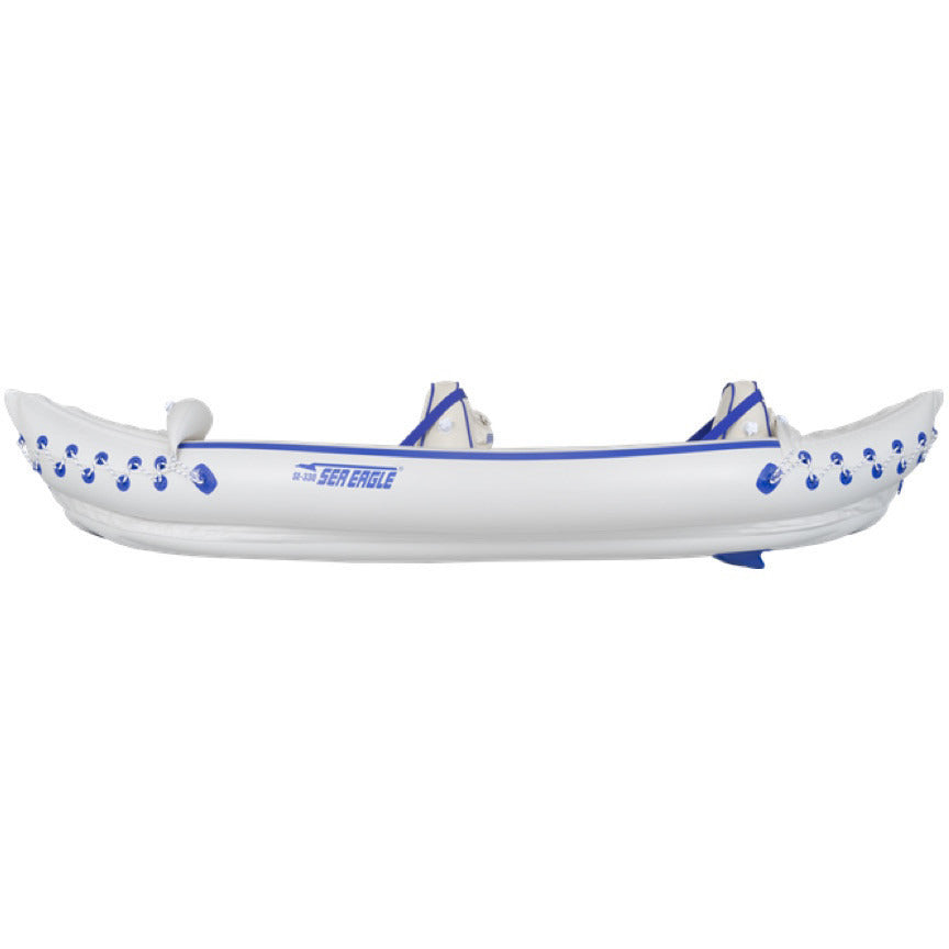 White and blue Sea Eagle 330 Sport Inflatable Kayak top view with the bag and pump sitting next to the Sea Eagle inflatable boat.