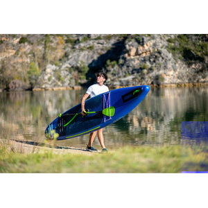 Neva 12.6 Inflatable Paddle Board inflated being carried by an adult male near a body of water